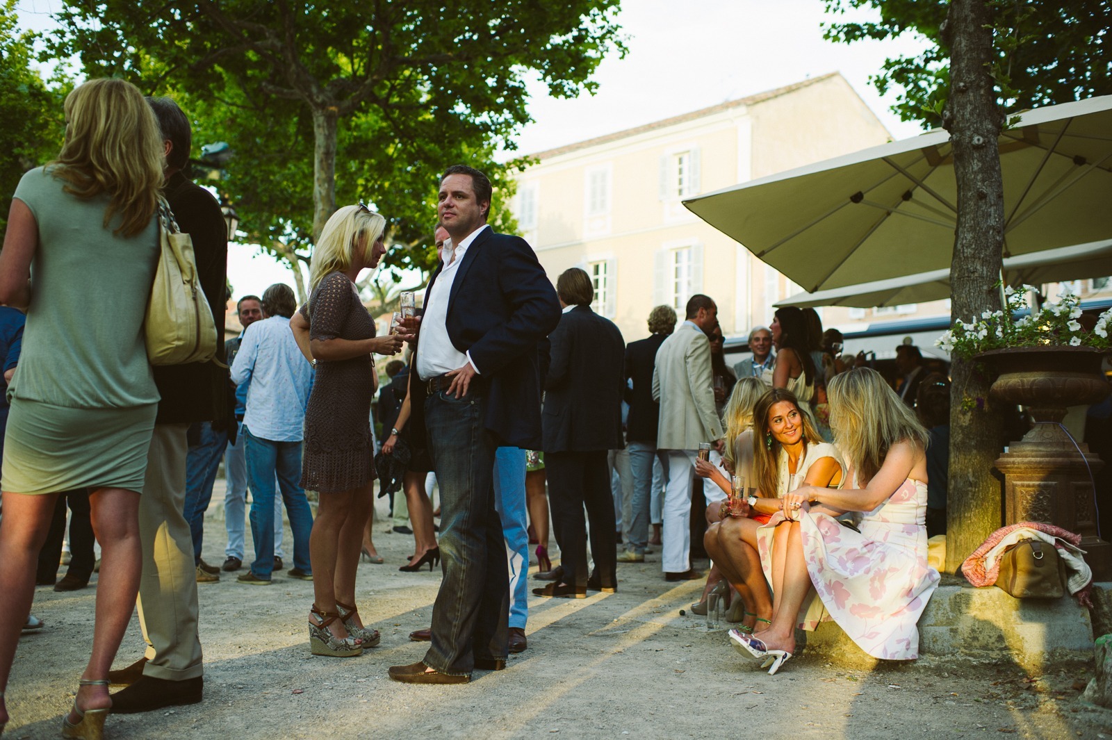 Guests enjoying food and drinks at Saint-Tropez rehearsal dinner