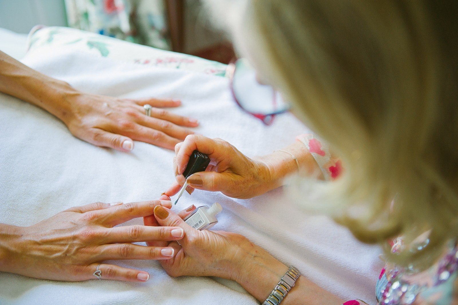 Groom checking his tie in mirror before vineyard ceremony near Saint-Tropez