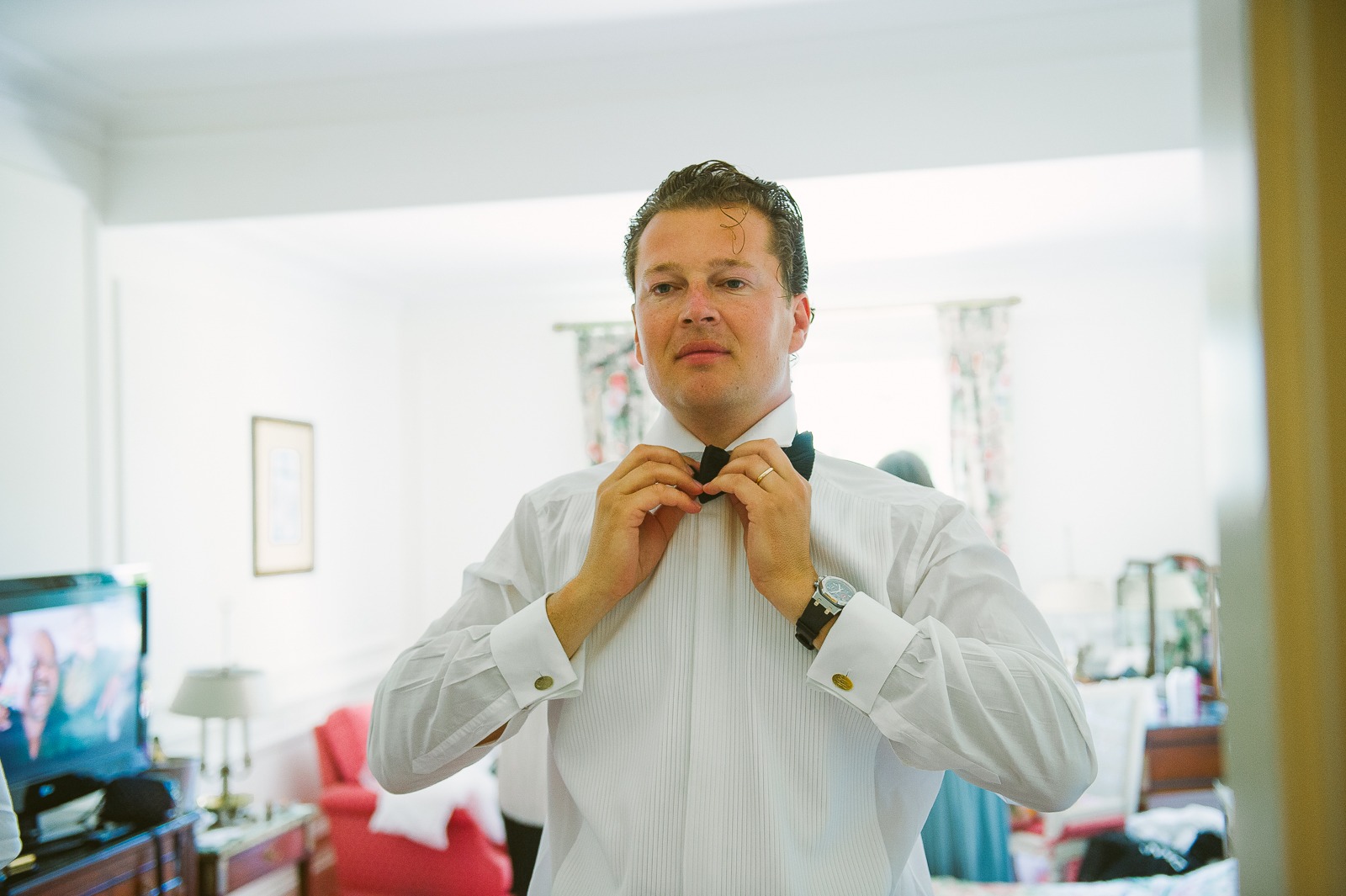 Bride looking out of window with Saint-Tropez view behind her