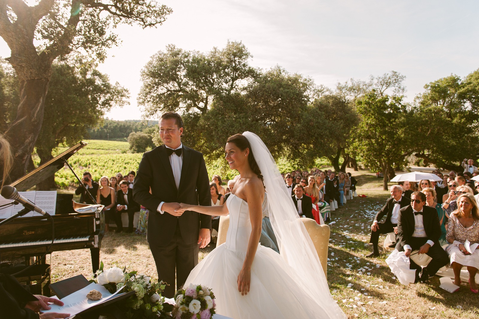 Couple walking away from ceremony area through vineyard near Saint-Tropez