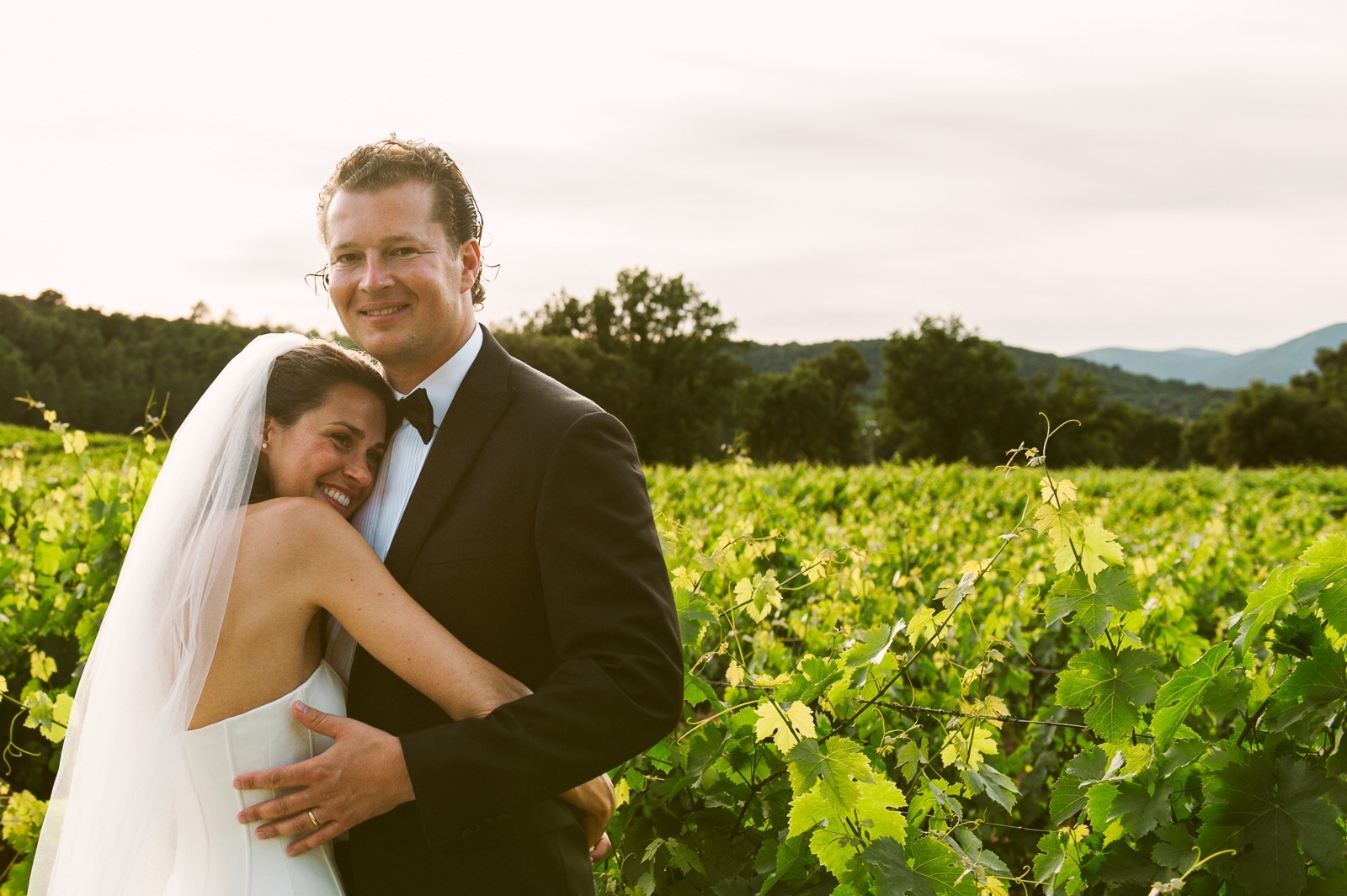 Bride touching groom's face during vineyard photoshoot near Saint-Tropez
