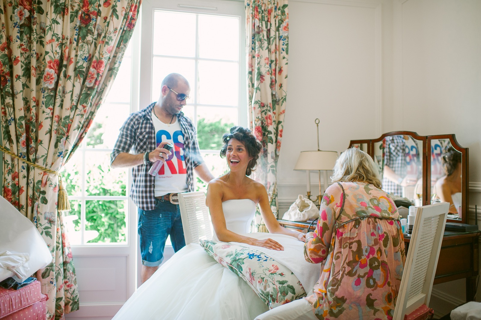 Bride adjusting her dress while getting ready in Saint-Tropez hotel