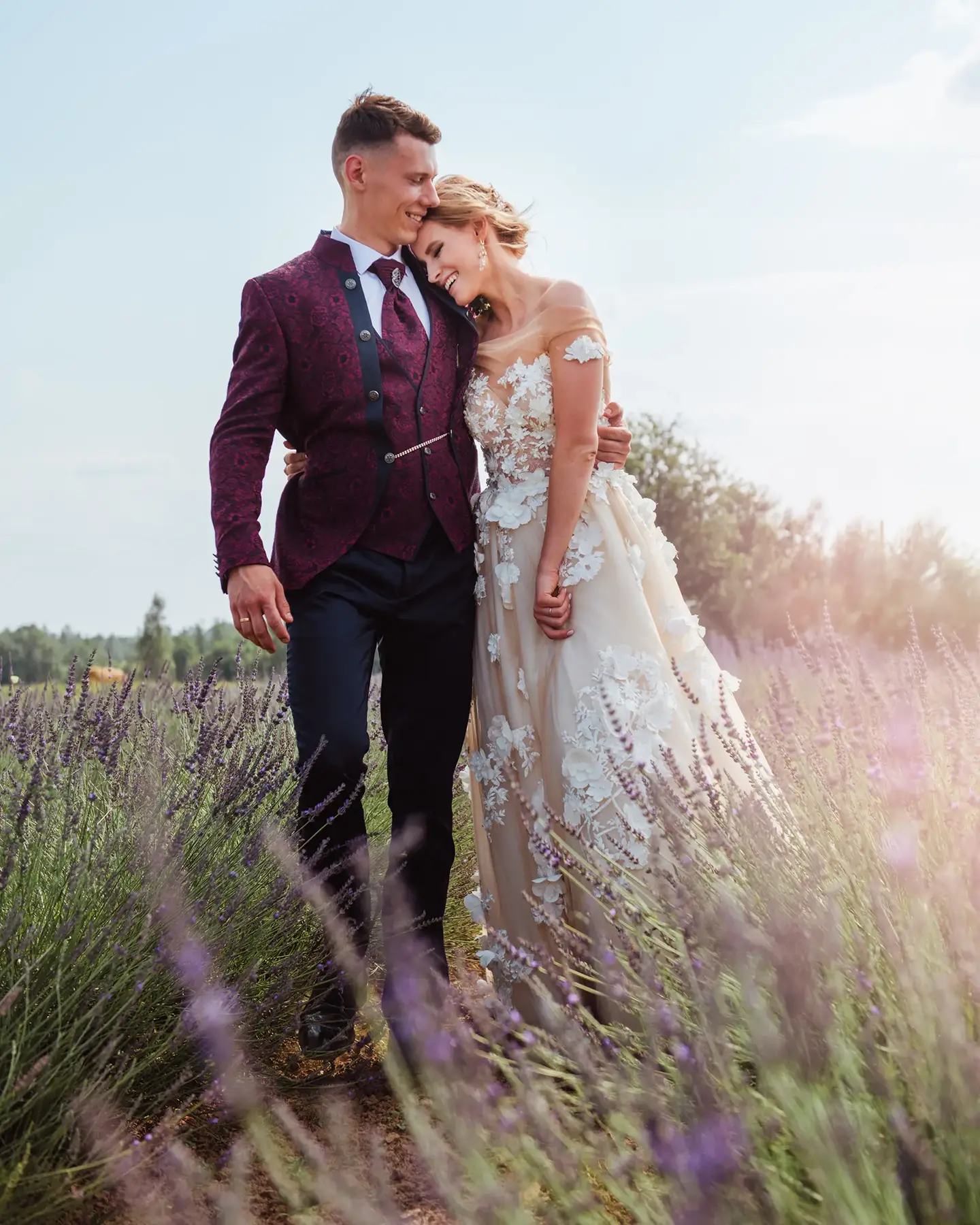 Bride and groom in a sunlit lavender field in Gordes, Provence