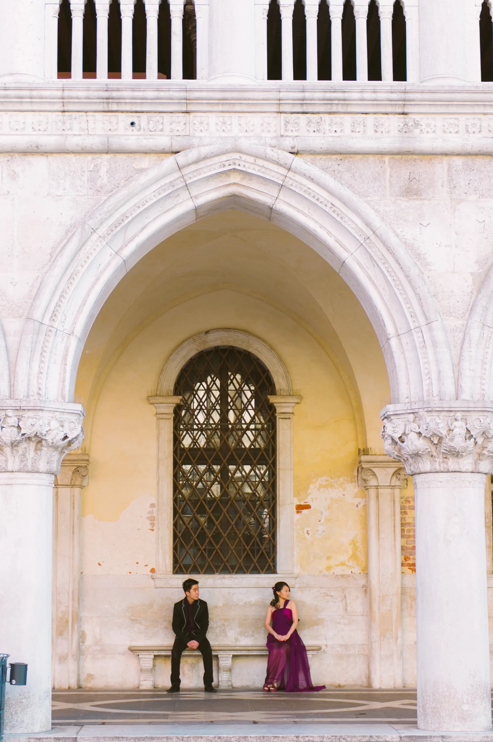 Masked pre-wedding couple in Venice at night with reflections