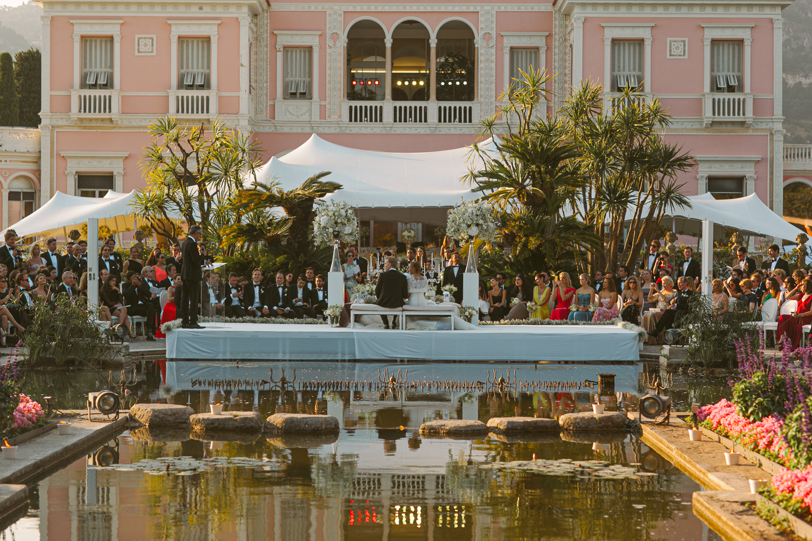 Overview of the Italian garden and pink villa at Villa Ephrussi de Rothschild during a wedding day.