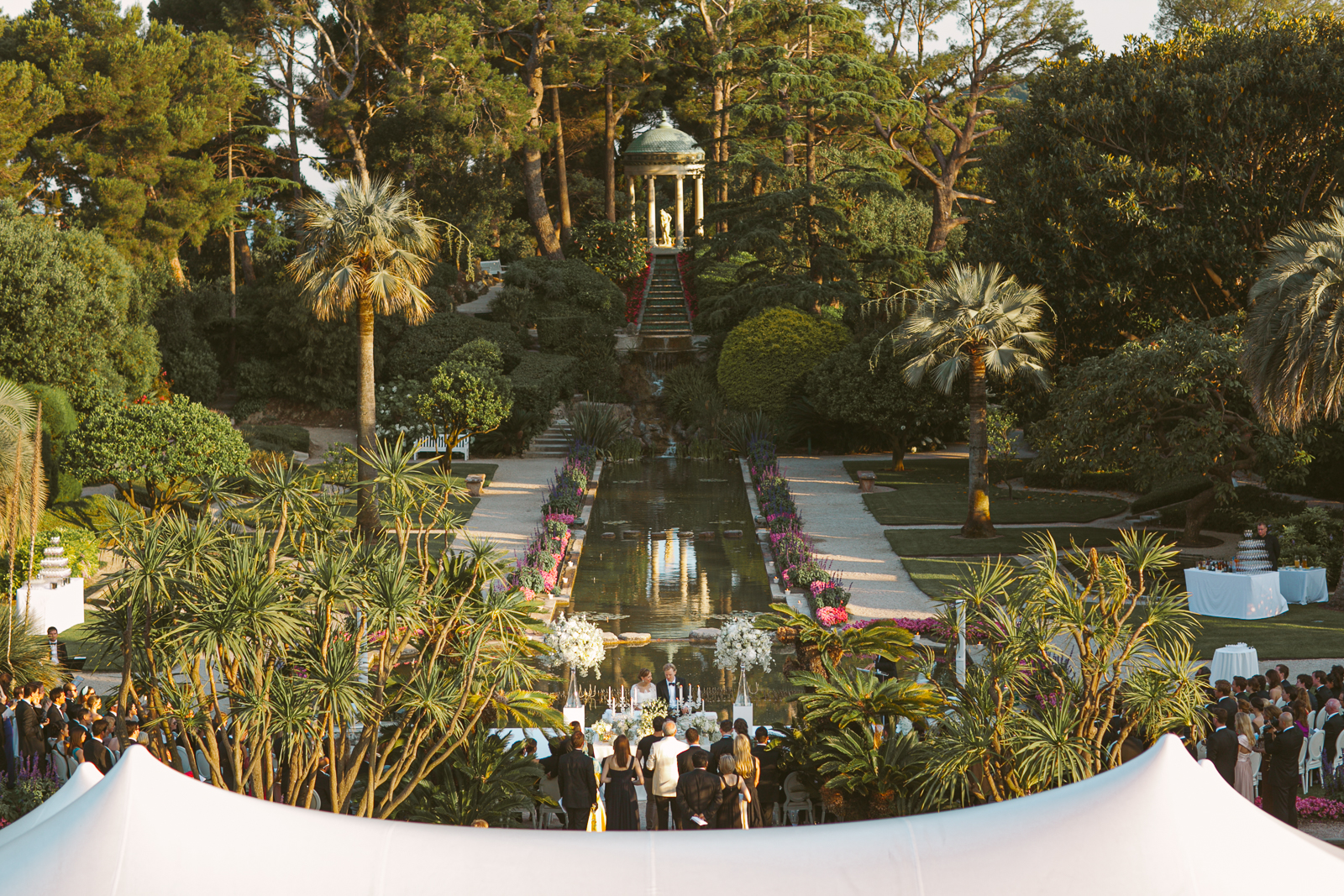 Guests enjoying sunset drinks in the gardens of Villa Ephrussi de Rothschild.