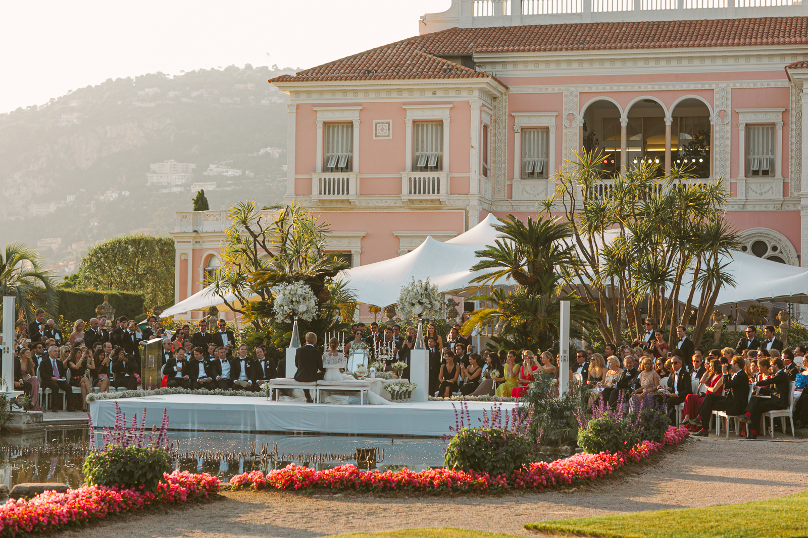 Guests mingling in the gardens of Villa Ephrussi during cocktail hour.