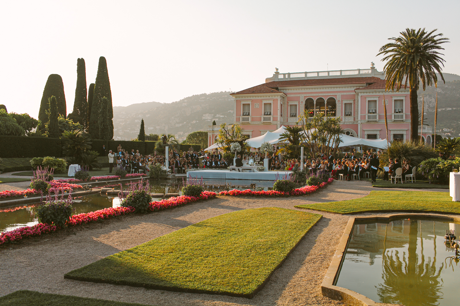 Persian wedding ceremony taking place with the Italian garden and fountains of Villa Ephrussi de Rothschild in the background.