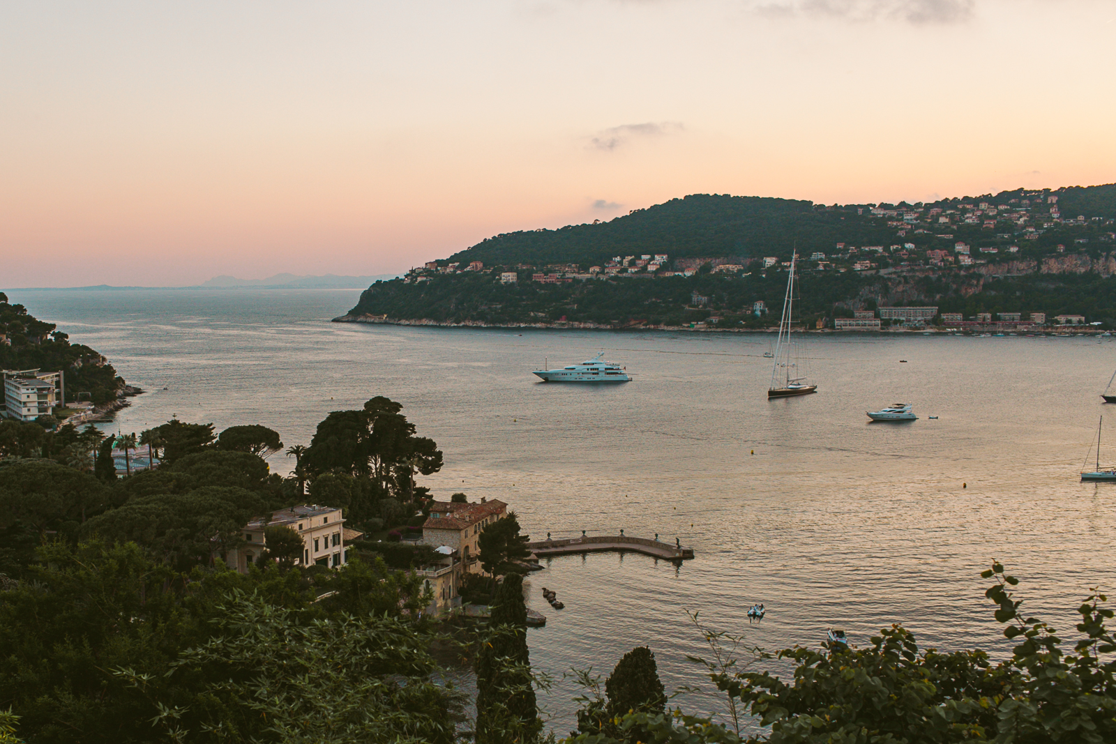 Romantic wedding portrait in the cypress alley at Villa Ephrussi with warm evening light.