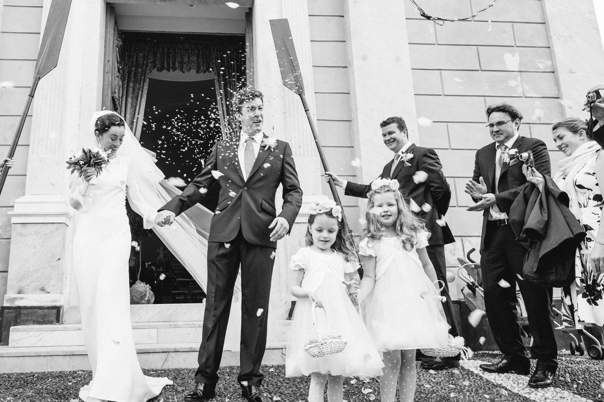 Bride and groom leaving the ceremony during a confetti throw near Portofino