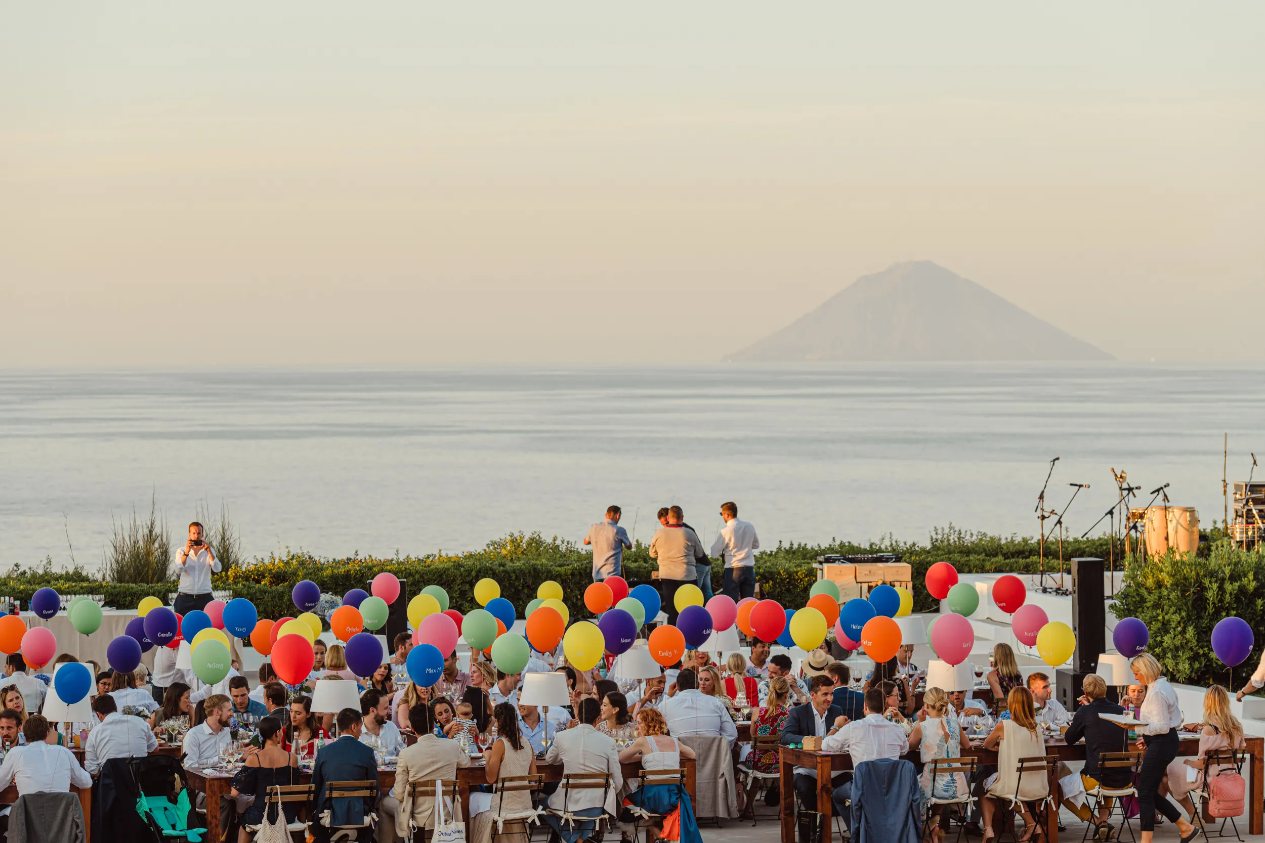 Outdoor wedding reception in Salina, Sicily with Stromboli volcano in the background