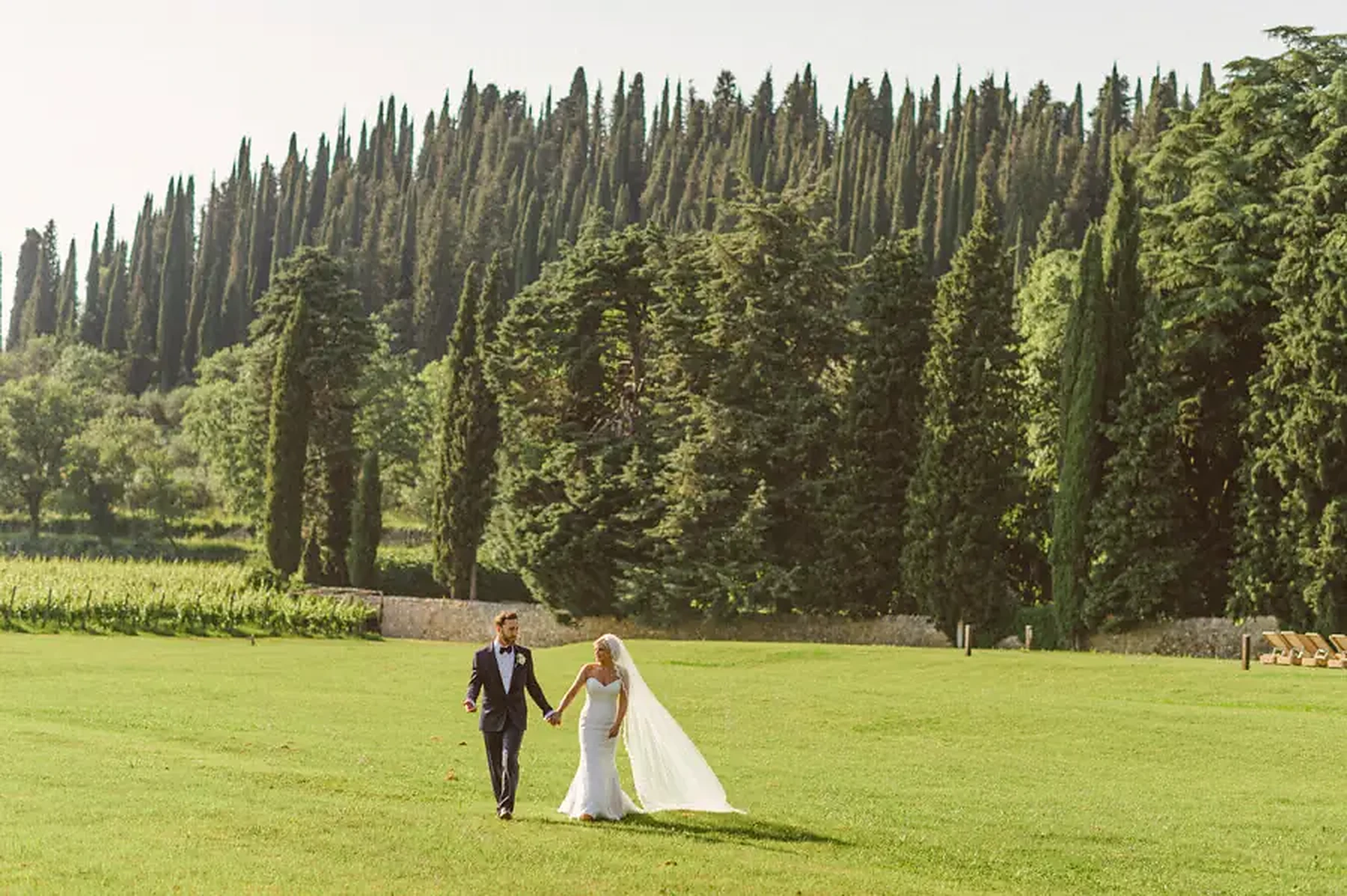 Bride and groom photographed in golden hour light during a Tuscany countryside wedding