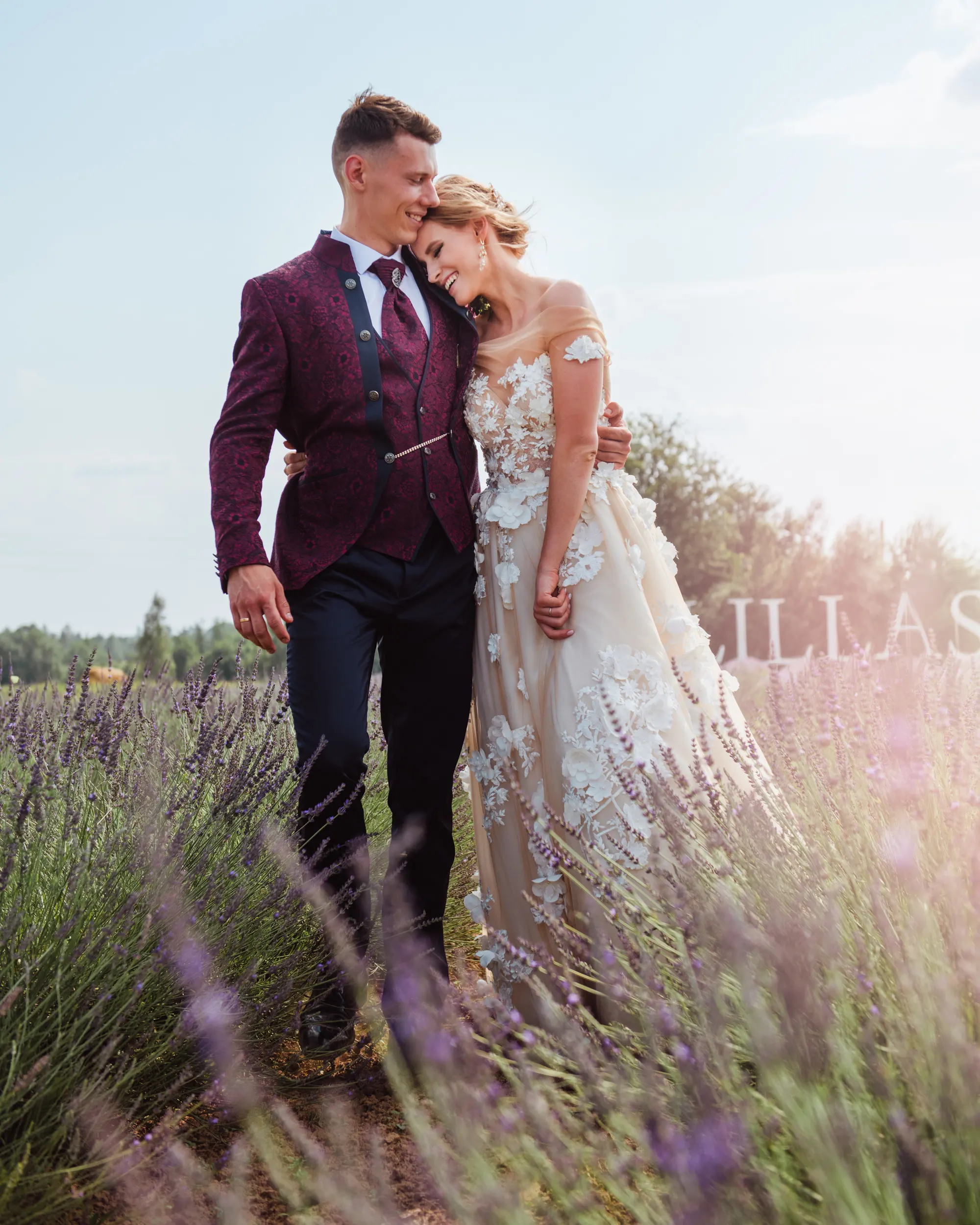 Bride and groom walking through lavender in Tuscany, photographed by Tuscany wedding photographer Janis Ratnieks