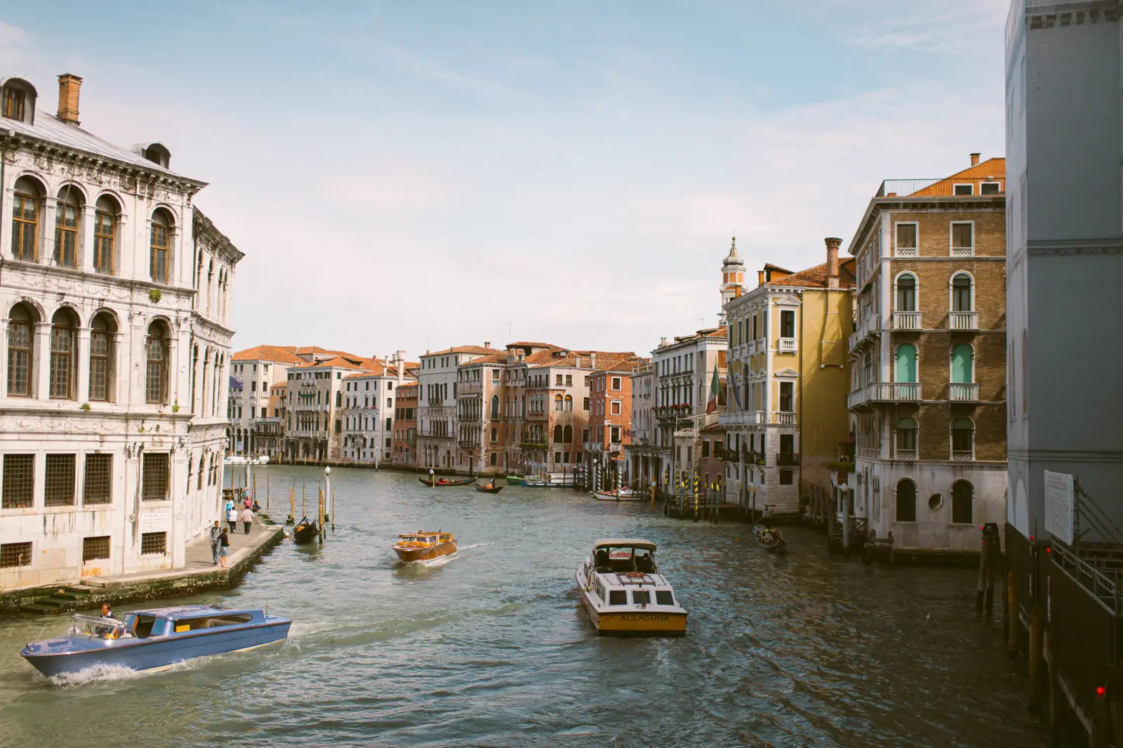 Bride and groom travelling by water taxi during a Venice wedding
